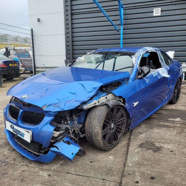 blue scrap BMW with damaged front end that is to be used for parts